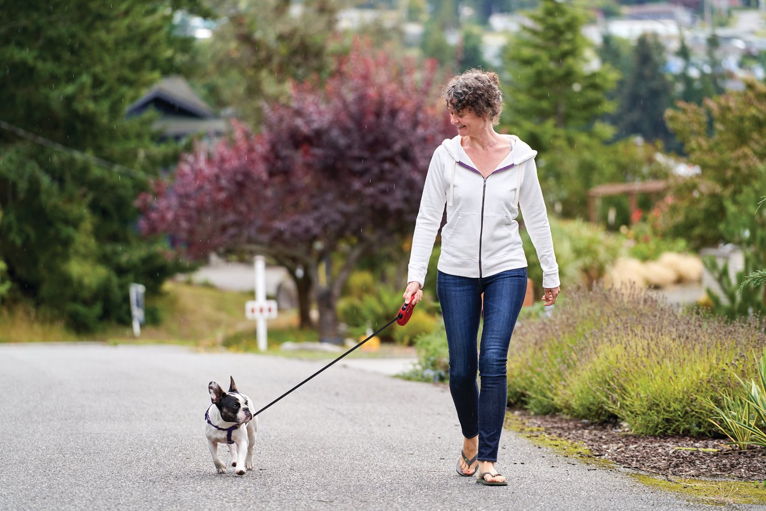 Olia Kerzhner walks her dog, wearing one of the women’s zip hoodies.